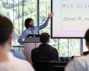 Gentleman standing and gesticulating at a whiteboard