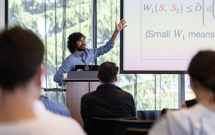 Gentleman standing and gesticulating at a whiteboard